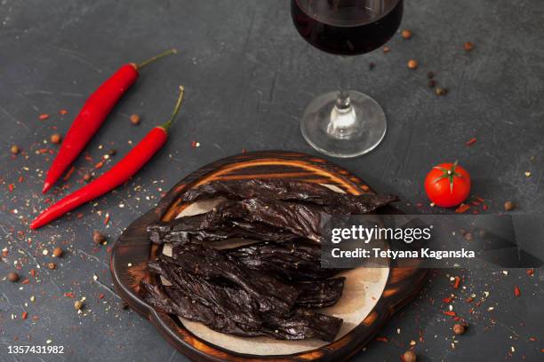 dry meat, red vine and vegetables on black background - protein bar fotografías e imágenes de stock