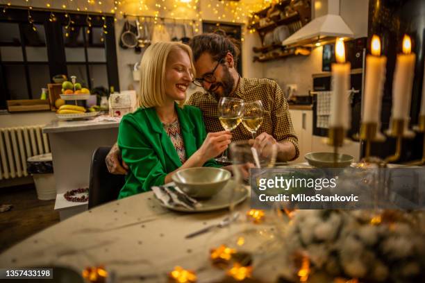 cheerful couple celebrating new year at home - new years eve dinner stock pictures, royalty-free photos & images