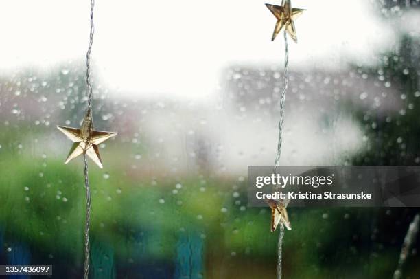 christmas light decoration in a window - rain background stock pictures, royalty-free photos & images