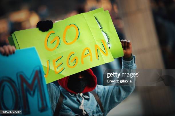 climate change and animal rights activists in the street. - vegan activist stock pictures, royalty-free photos & images