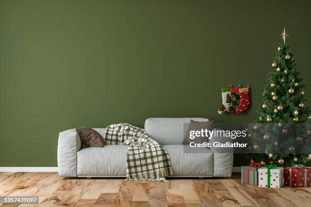 empty simple living room with gray sofa, christmas tree and gifts - stocking tops stock pictures, royalty-free photos & images