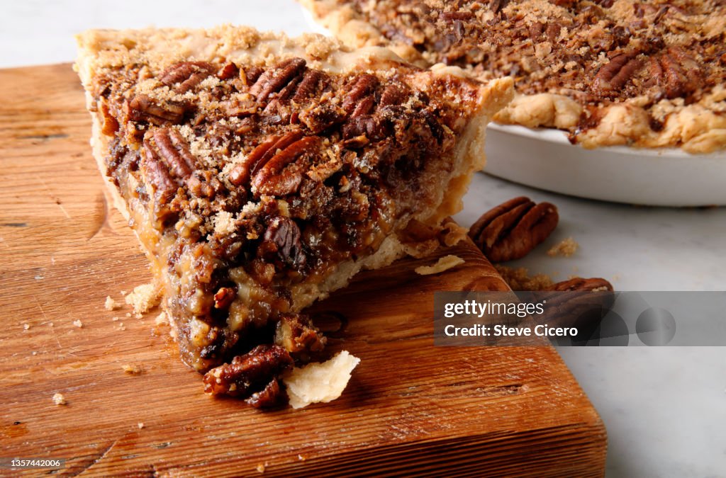 Sliced pecan pie on countertop