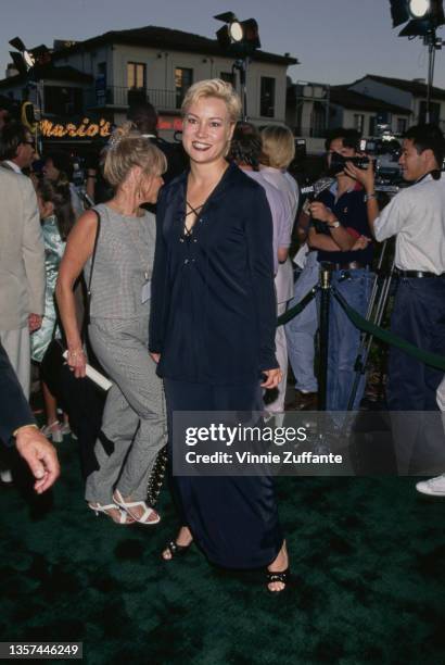 American-Canadian actress Jennifer Tilly, wearing a black suit with a long black skirt and a lace-up jacket, attends the Westwood premiere of 'Tin...