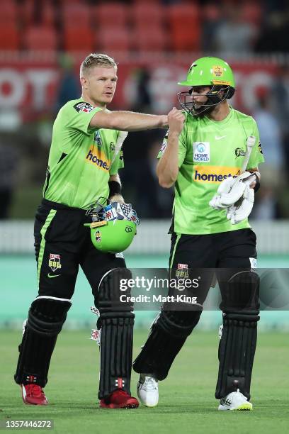 Sam Billings and Alex Ross of the Thunder celebrate victory after the Men's Big Bash League match between the Sydney Thunder and the Brisbane Heat at...