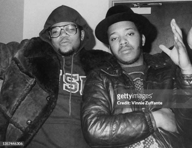 American rapper Darryl 'DMC' McDaniels, the hood of his hoodie pulled over his head, and American rapper Joseph 'Run' Simmons his left hand raised,...