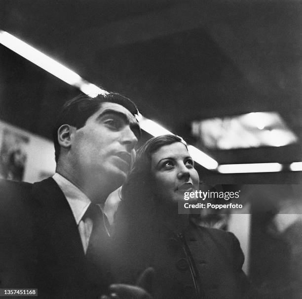 Hungarian born American photographer Robert Capa visits an exhibition of war photographs by Illustrated Magazine photographers at Dorland Hall in...