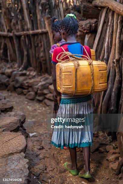 african girls carrying water from the well, ethiopia, africa - native african girls stock pictures, royalty-free photos & images