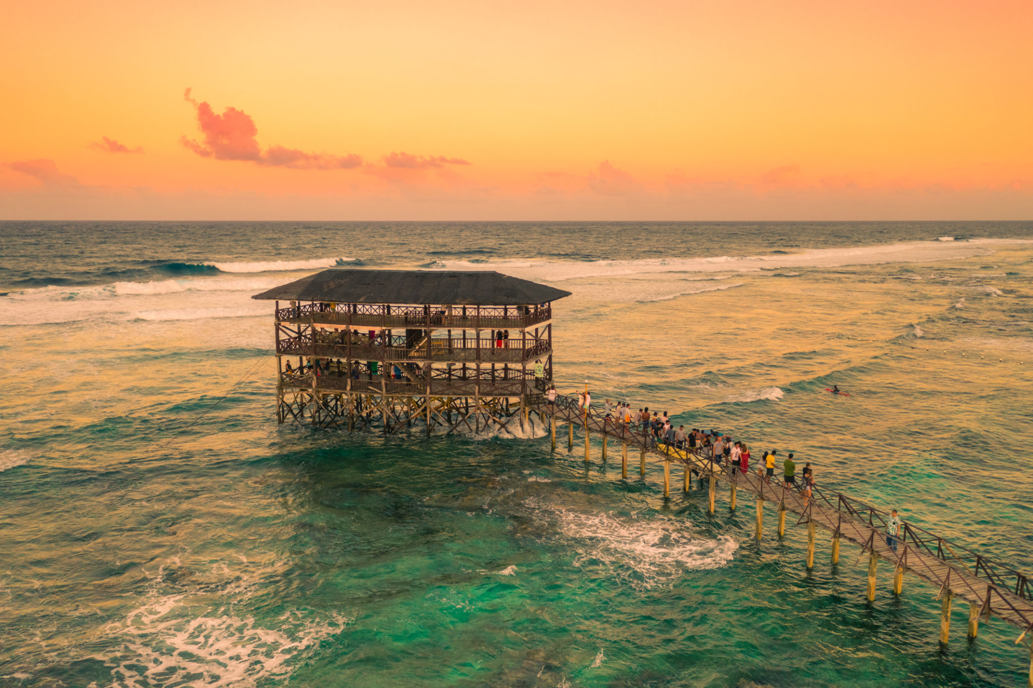 Sunset on most popular surfing area Cloud 9 at Siargao, Philippines. Aerial view raised wooden walkway for surfers to cross the reef of siargao island to cloud 9 surf break Mindanao. Sunset on most popular surfing area Cloud 9 at Siargao, Philippines. Aerial view raised wooden walkway for surfers to cross the reef of siargao island to cloud 9 surf break Mindanao.