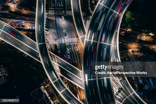 drone point view of overpass and city traffic at night - rise above it stock pictures, royalty-free photos & images