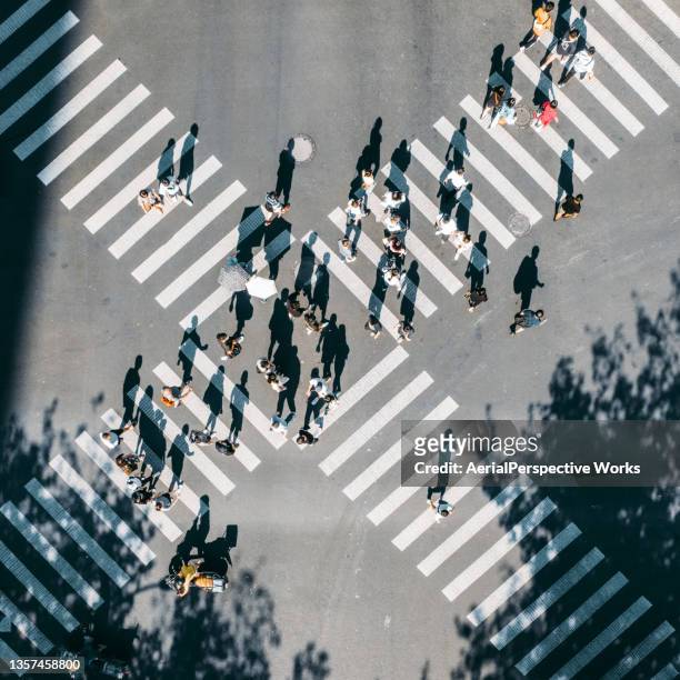 drone point view of city street crossing - crowd of people from above stock pictures, royalty-free photos & images