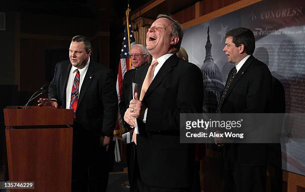 Senate Majority Whip Sen. Richard Durbin reacts as Sen. Jon Tester , Sen. Bernie Sanders , and Sen. Mark Begich look on during a news conference on...