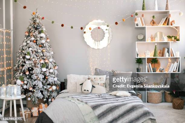 christmas tree decorating in home. - garland decoration stock pictures, royalty-free photos & images