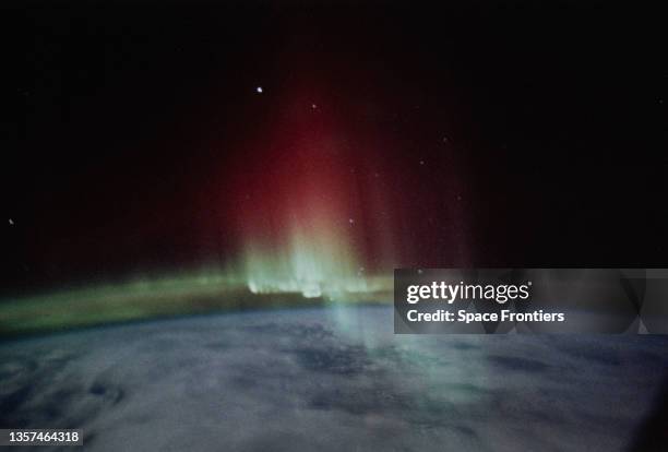 The Aurora Australis as seen from Space Shuttle Discovery during STS-39, showing a spiked band of red and green aurora above the Earth's Limb, 28th...