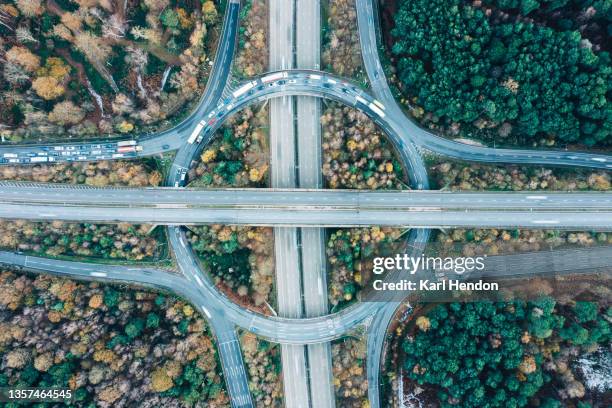 an aerial view of a motorway intersection - stock photo - interchange stock-fotos und bilder