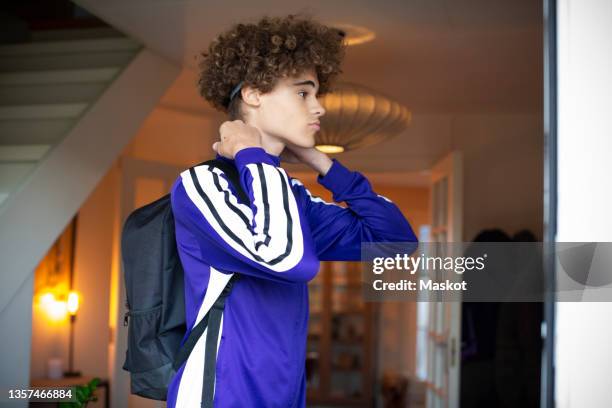 teenage boy getting dressed at home - sports jersey home stock pictures, royalty-free photos & images