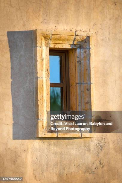 desert house with window lit up for sunrise at scottsdale, arizona - scottsdale arizona house stock pictures, royalty-free photos & images