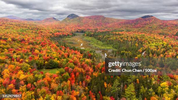 fall foliage at new england,scenic view of mountains against sky during autumn,groton,vermont,united states,usa - vermont stock-fotos und bilder