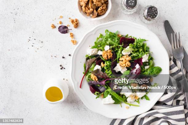 healthy beet salad with walnuts and cheese,russia - plain salad stock pictures, royalty-free photos & images