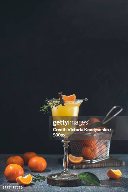 glass of refreshing tangerine margarita cocktail - tangerine martini stock pictures, royalty-free photos & images