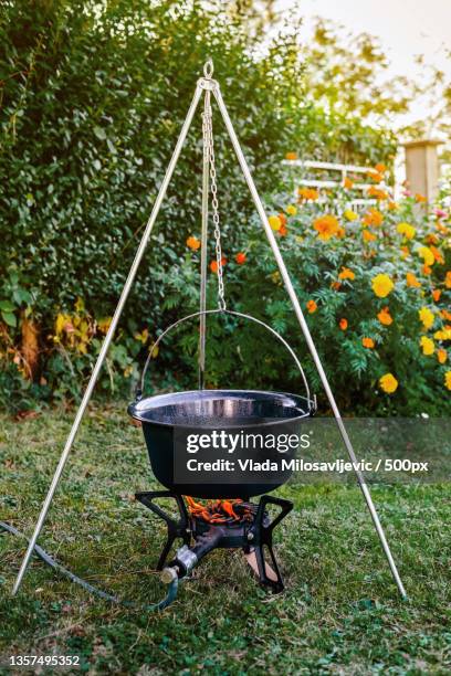 cooking beef goulash soup in a cauldron - iron cauldron stock pictures, royalty-free photos & images