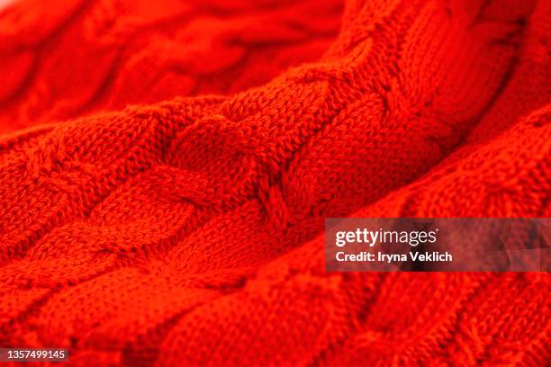 knitted sweater in red colour background. - red cardigan sweater stock pictures, royalty-free photos & images