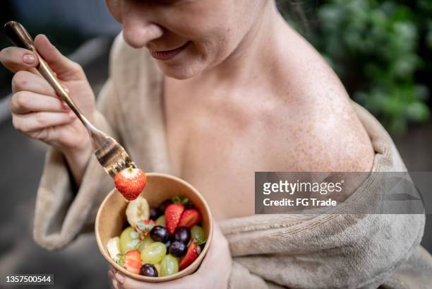 close up of an woman hands holding a bowl with fruits at a spa - antioxidants skin stock pictures, royalty-free photos & images