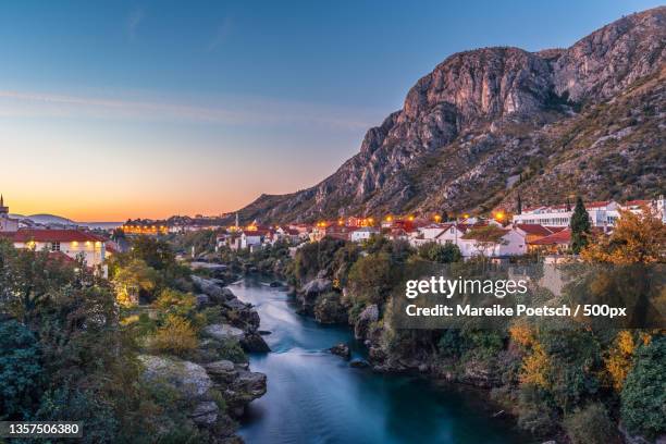 sunrise in mostar,bosnia and herzegovina,scenic view of river by mountains against sky during sunset,mostar - bosnia and hercegovina stock pictures, royalty-free photos & images