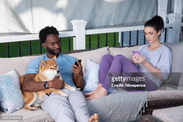a couple relaxing with their dog - rochester bundesstaat new york stock-fotos und bilder