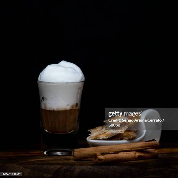 coffee with foam in a small tube glass on a wood coffee with foam in a small tube glass on a wood - creme tube ストックフォトと画像