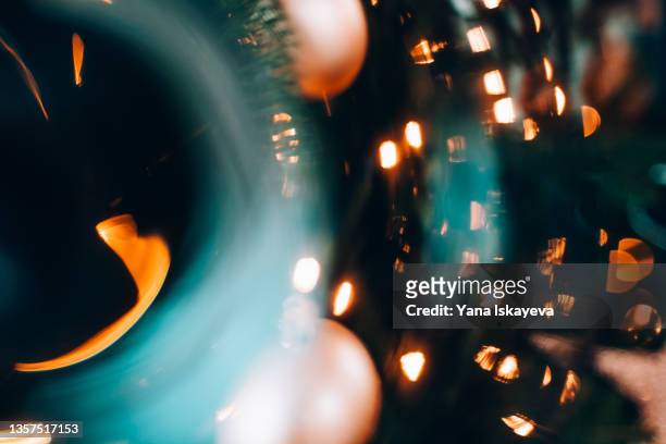 abstract festive holiday background with golden glitters and lens flare - lens flair stock-fotos und bilder