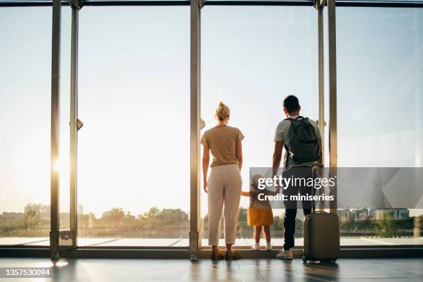 unrecognizable family going on holiday together - rear view hand window stockfoto's en -beelden