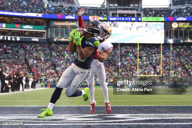Tyler Lockett of the Seattle Seahawks catches a pass against Josh Norman of the San Francisco 49ers for a touchdown during the third quarter at Lumen...
