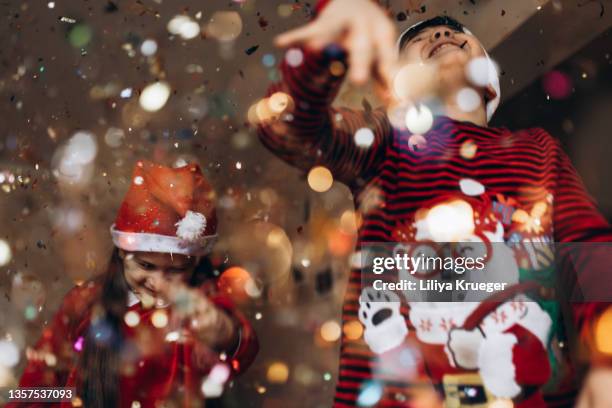 children dancing under glittering confetti. - party under stock pictures, royalty-free photos & images