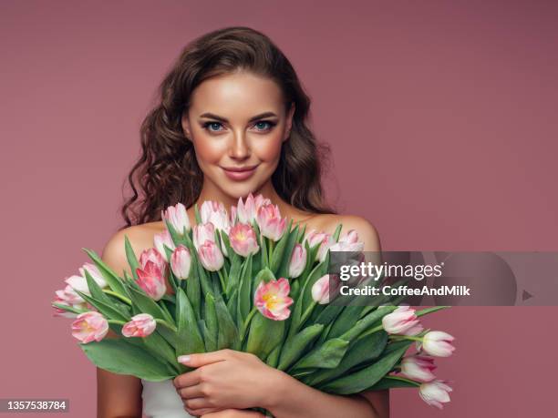 young beautiful woman holding a bouquet of flowers - faces smile celebrate stock pictures, royalty-free photos & images