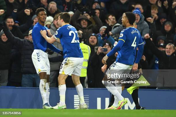 Demarai Gray of Everton celebrates with teammates Seamus Coleman and Mason Holgate after scoring their side's second goal during the Premier League...