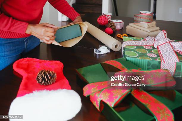 woman wraps christmas gifts - stocking tops stock pictures, royalty-free photos & images