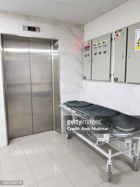 emergency care stretcher near elevator door for any emergency exit in a hospital. - distribution board stock pictures, royalty-free photos & images