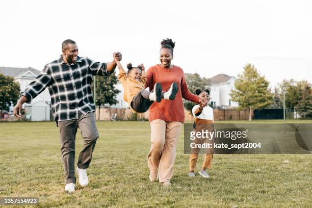 family enjoying springtime outdoors with kids - playing stock pictures, royalty-free photos & images