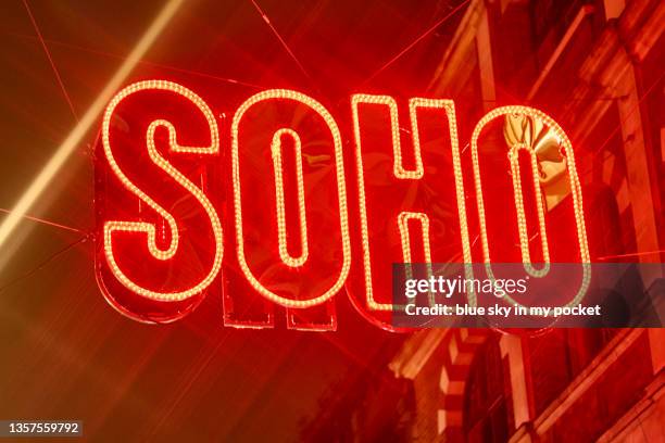 a close-up of the large illuminated  soho sign in london in december - soho london fotografías e imágenes de stock