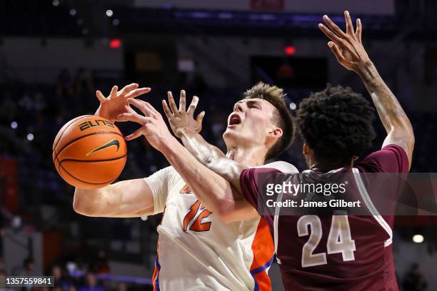 Colin Castleton of the Florida Gators is fouled by John Walker III of the Texas Southern Tigers during the first half at Stephen C. O'Connell Center...