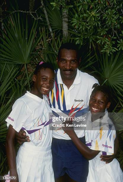Serena Williams stands with her sister Venus Williams and father Richard Williams at a tennis camp in Florida. Mandatory Credit: Ken Levine /Allsport