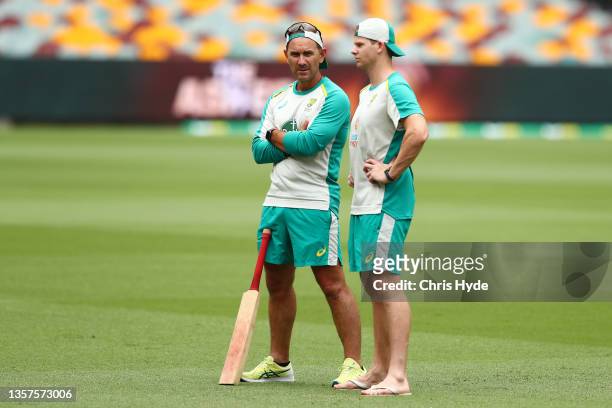 Head coach Justin Langer and Steve Smith talk during an Australian Ashes squad nets session at The Gabba on December 07, 2021 in Brisbane, Australia.