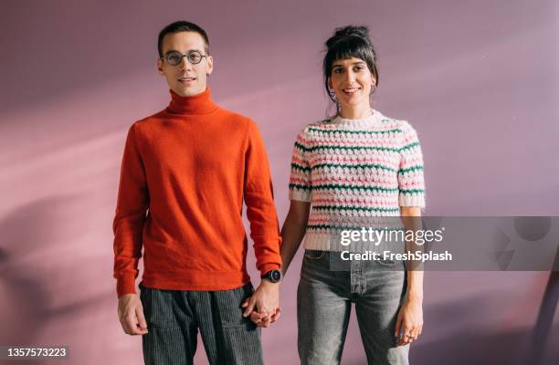 a beautiful young couple looking at camera - polo neck stock pictures, royalty-free photos & images