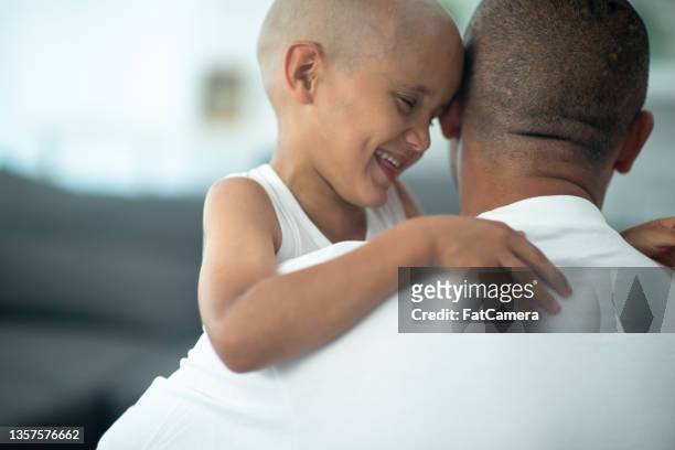 hugging dad - childhood cancer stock pictures, royalty-free photos & images