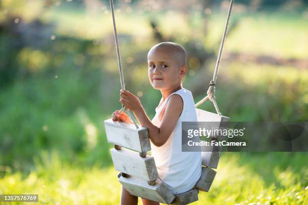 swinging outside - shaved head stock pictures, royalty-free photos & images