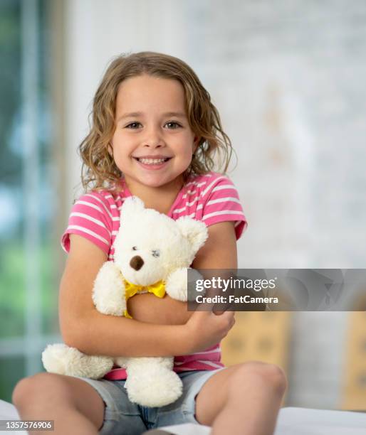 little girl and her teddy bear - teddy day stockfoto's en -beelden