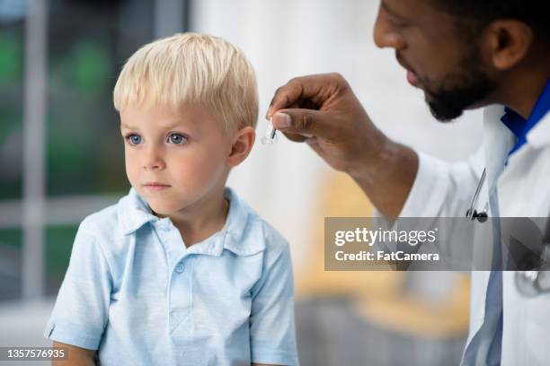 being fitted for a hearing aid - hearing aids stock pictures, royalty-free photos & images