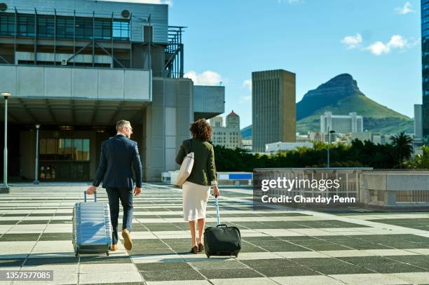 shot of two business people traveling in the city - representing stock pictures, royalty-free photos & images