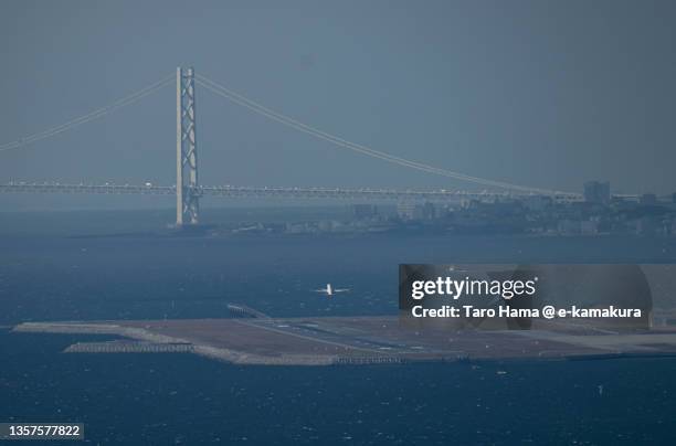 the airplane flying over the sea in kobe city of japan - região de kinki imagens e fotografias de stock