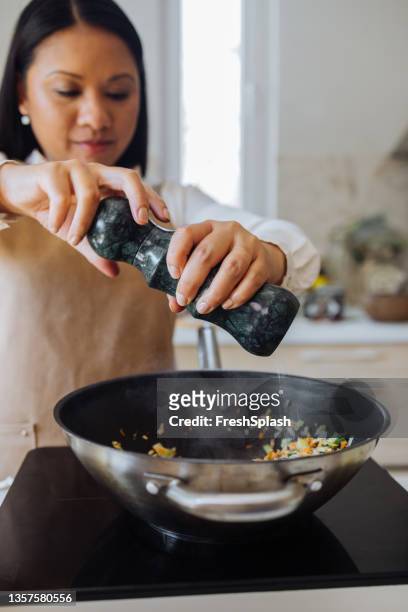 beautiful woman preparing healthy meal in her kitchen - hot filipina women stock pictures, royalty-free photos & images